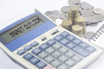 Coins and calculator with business and finance conceptual text.