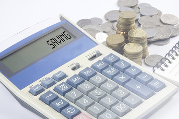 Coins and calculator with business and finance conceptual text.