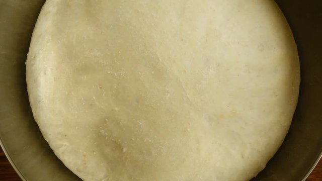 Closeup 4k video of yeast dough increases, time lapse