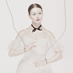 ballet dancer as puppet dancing over white background