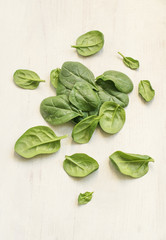 spinach leaves on a white wooden  background 
