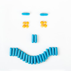 Happy smile made from many pills and capsules. wellness concept
