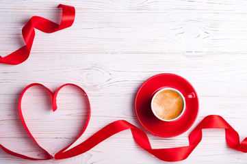 Valentines background with red heart and coffee cup. Valentines Day greeting card. Coffee break. Top view