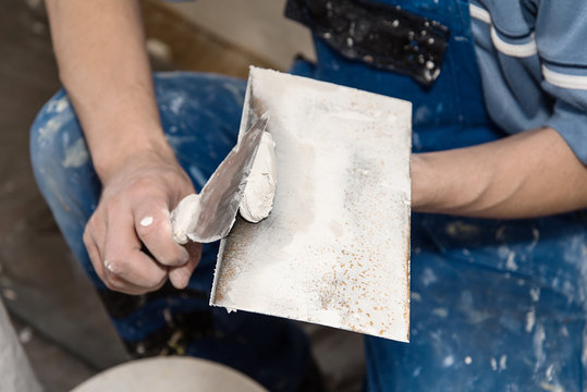 Painting Worker Repair Wall Using A Paint Spatula Hand