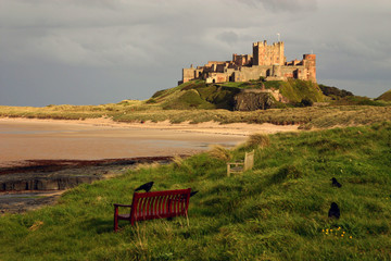 Bamburgh Castle. The castle sits on a basalt outcrop overlooking the Farne Islands and Lindisfarne....