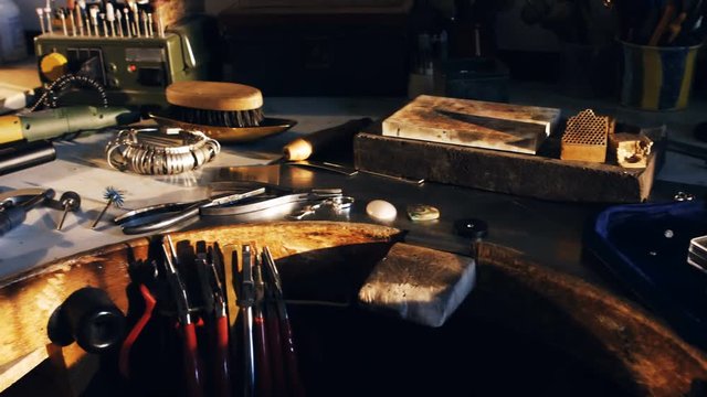 Goldsmith work tools on workbench in workshop