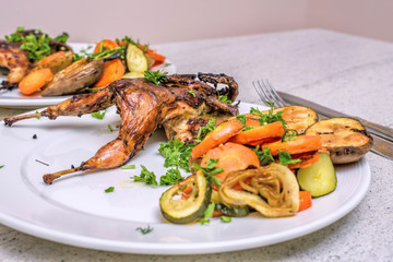 Roasted homemade quail with vegetables. Healthy food. Perfect dinner for two