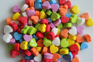 Fototapeta na wymiar A variety of tinsel colorful hearts for Valentine's Day.