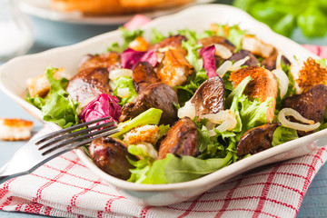 Warm salad with grilled chicken liver and toast