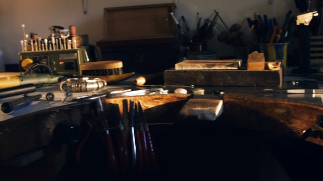 Goldsmith work tools on workbench in workshop