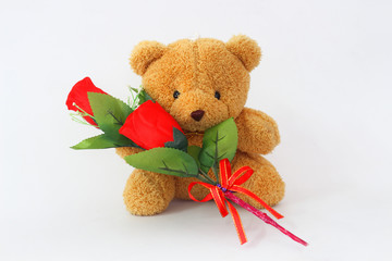 Brown teddy bears and red roses on a white background.