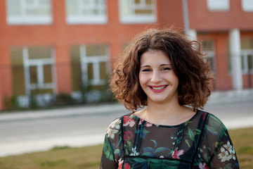 Fototapeta premium Happy curvy girl with curly hair in the street