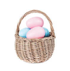 Basket with Easter eggs on white background
