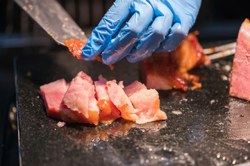 Chef Carving Slices Of Roast ham
