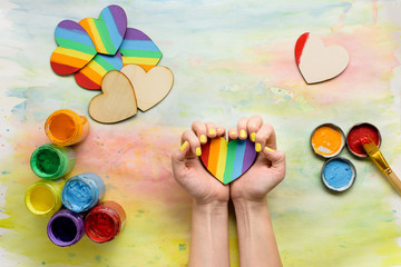 Hands holding handmade lgbt hearts