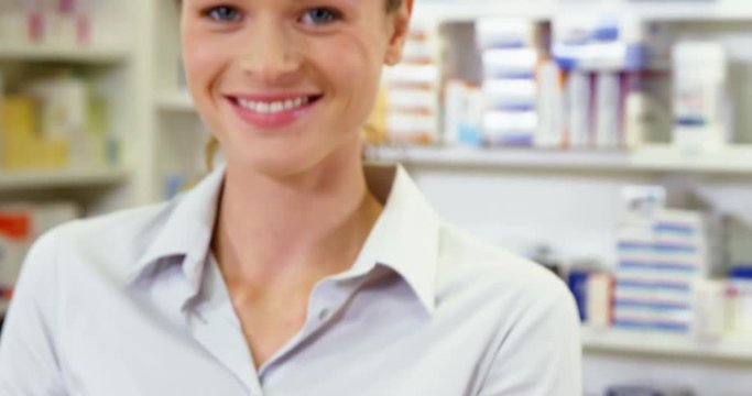 Portrait of pharmacist taking pills in pharmacy