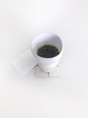 Cup of hot drip coffee / brew coffee on white paper, isolated on white background