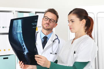 doctors looking at x-ray in medical office