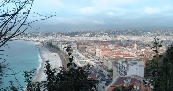 Landscape and azure sea with beach walking people riding cars on the road tourist town in spring season.time lapse