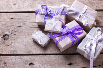 Gift boxes with presents  on aged wooden background.
