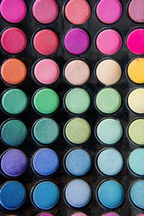 Palette of colorful eye shadows and make up brush