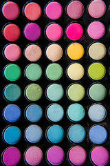 Palette of colorful eye shadows and make up brush