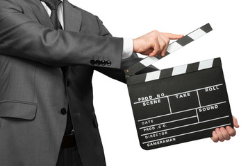 Man wearing costume holding clapper board