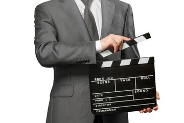 Man holding movie clapper board on white