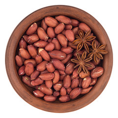 Peanuts with star anise in a ceramic bowl. T