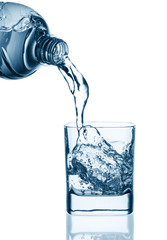 Water pouring from bottle into glass