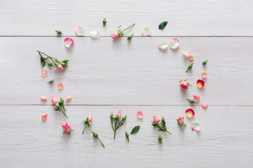 Flower shop background, roses frame on white wood