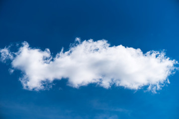 Fototapeta na wymiar Single white cloud on blue sky