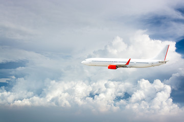 Fototapeta na wymiar Airplane flying above clouds.