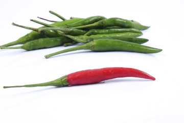 Red chili on green chillies on white background concept : different, win, better