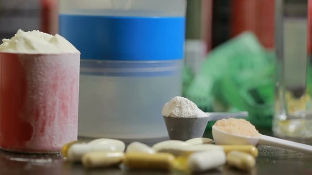 protein, bcaa, omega3 in pills on wooden background. sports nutrition concept