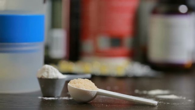 protein, bcaa, omega3 in pills on wooden background. sports nutrition concept