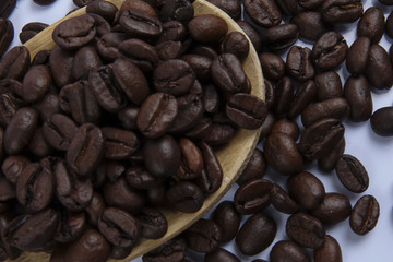 roasted coffee beans isolated on white background close up.