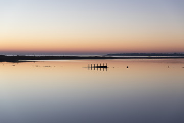 sunset with reflection in still water over nature reserve Casse de la Belle Henriette, Vendee, France