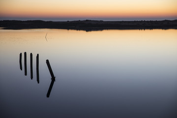 sunset with reflection in still water over nature reserve Casse de la Belle Henriette, Vendee, France
