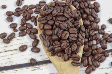 coffee beans and wooden spoon on old rusty background