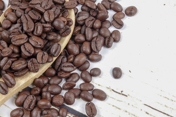 coffee beans and wooden spoon on old rusty background