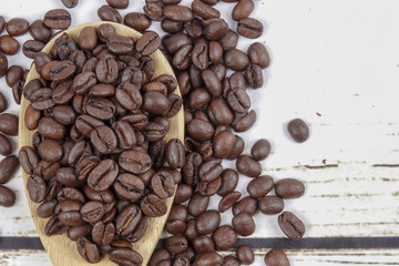 coffee beans and wooden spoon on old rusty background