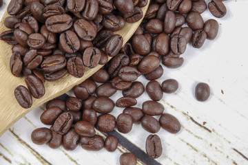 coffee beans and wooden spoon on old rusty background