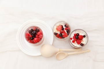 cottage cheese with berries in a glass on a white background