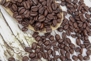 coffee beans and wooden spoon on old rusty background
