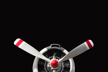 Vintage airplane propeller with radial engine on black background