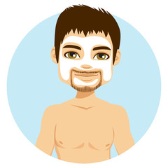 Young handsome man with cream moisturizer on face