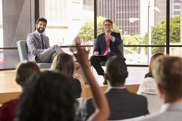 Speakers at a business seminar take questions from audience