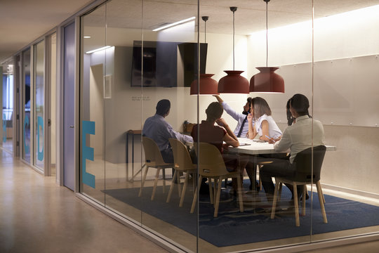 Corporate business team using AV display in meeting cubicle