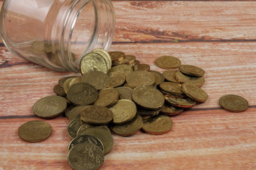 Coins in the bottle on wooden background,saving money and business concept